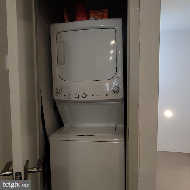 laundry room with stacked washer and dryer