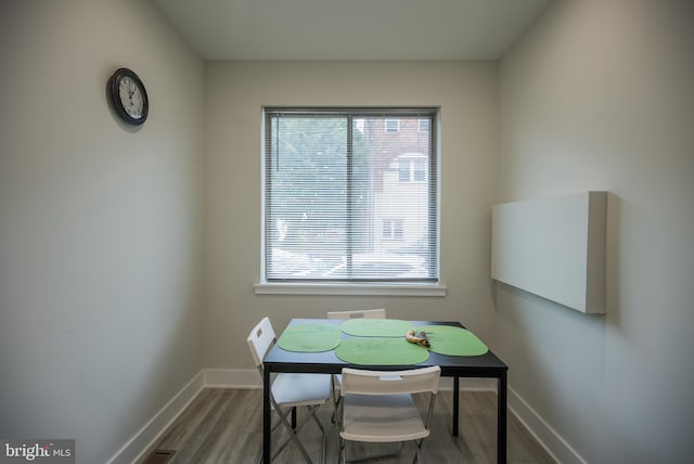 dining room featuring dark hardwood / wood-style floors and a healthy amount of sunlight