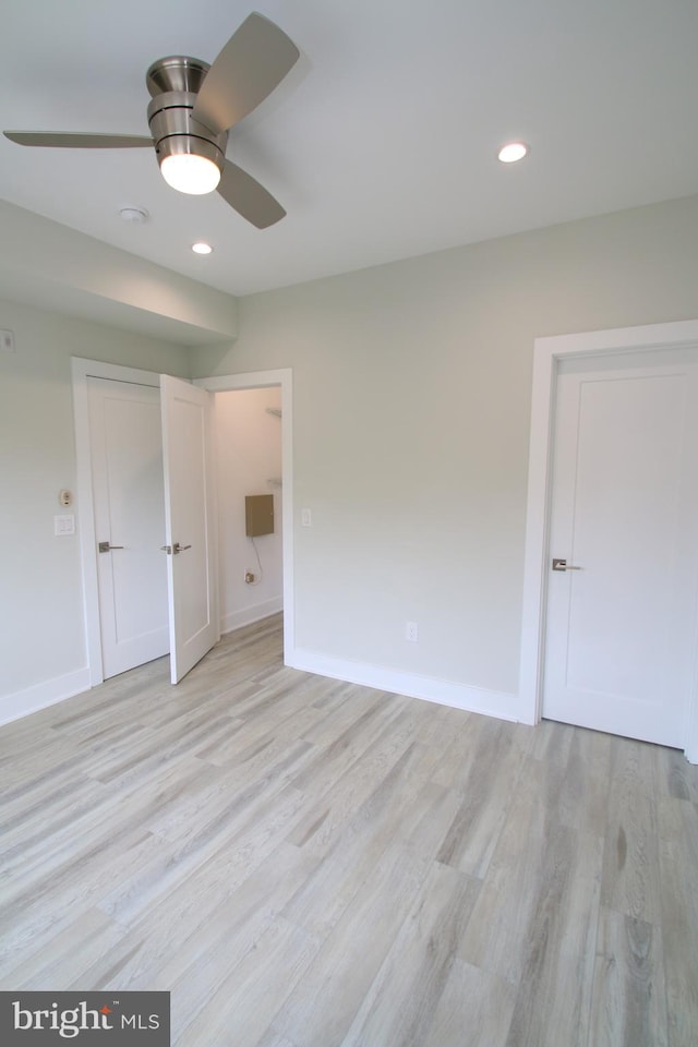 unfurnished bedroom featuring light wood-type flooring and ceiling fan