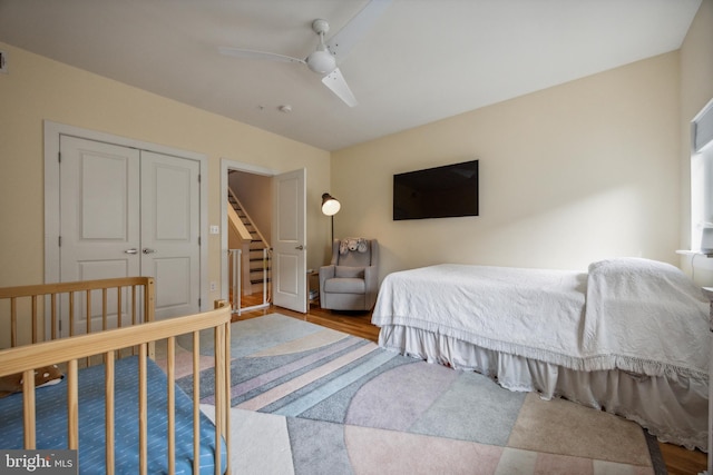 bedroom with ceiling fan, a closet, and hardwood / wood-style flooring