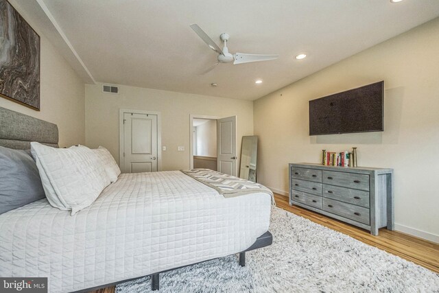 bedroom with ceiling fan and light hardwood / wood-style floors