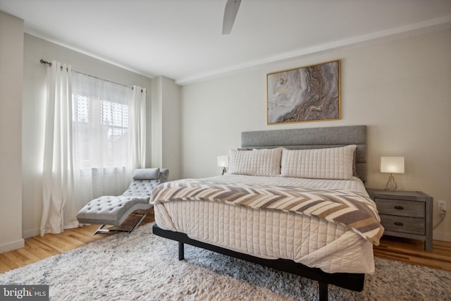 bedroom with ceiling fan and hardwood / wood-style flooring