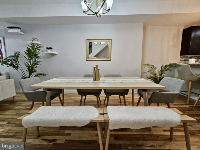 dining space featuring a notable chandelier and wood-type flooring