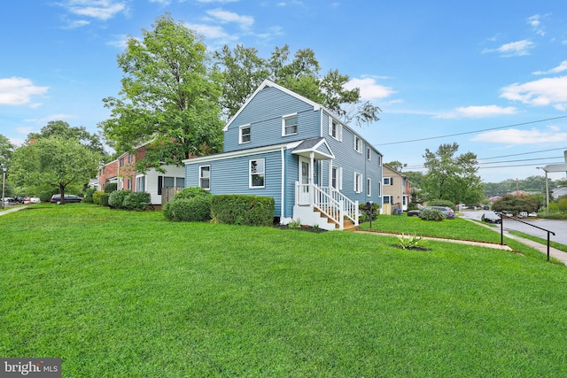 view of side of property with a yard