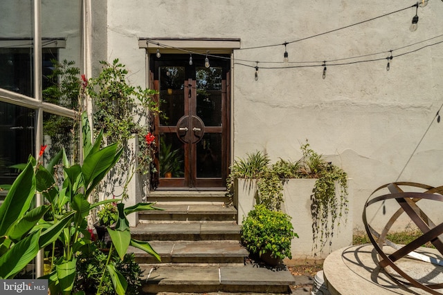 doorway to property with french doors and stucco siding