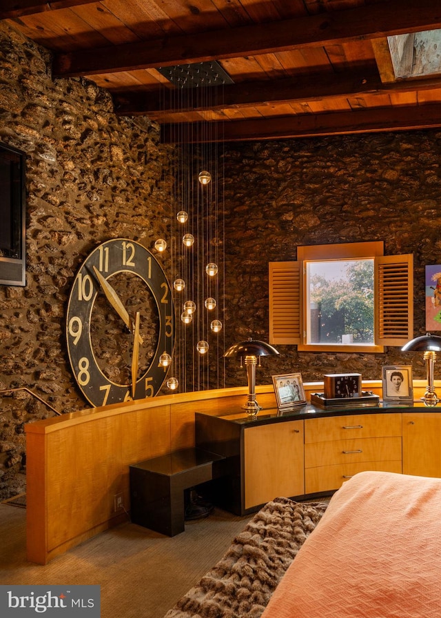 interior space featuring wood ceiling, carpet floors, beam ceiling, and a skylight