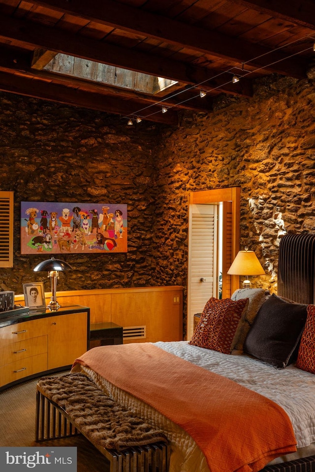 bedroom with wood ceiling and beam ceiling