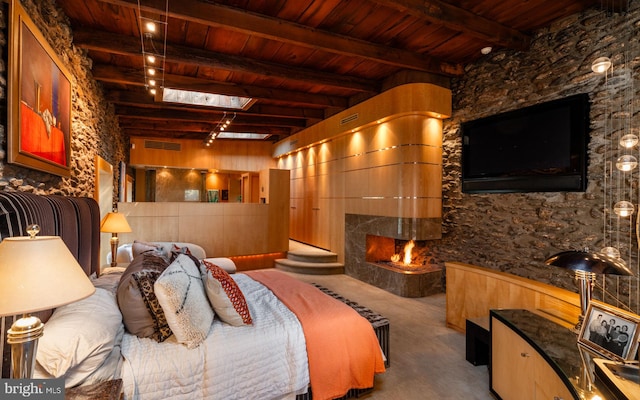 bedroom featuring beam ceiling, a premium fireplace, and wood ceiling