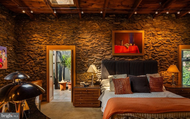 bedroom featuring ensuite bathroom, beam ceiling, and wooden ceiling