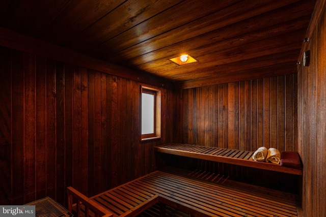 view of sauna with wooden walls and wooden ceiling