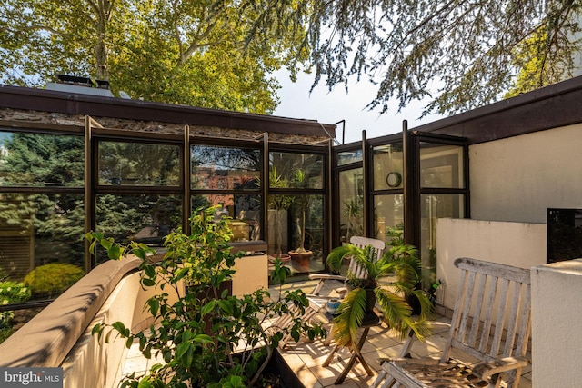 view of patio / terrace featuring a sunroom