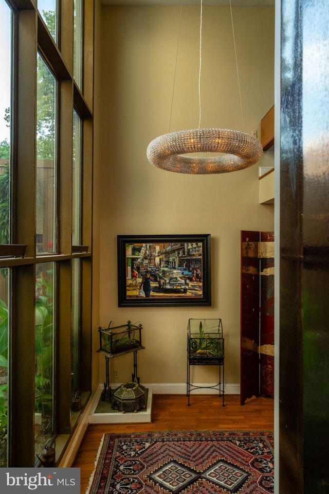 corridor featuring wood finished floors and baseboards