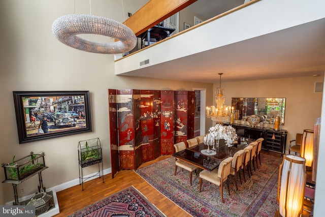 dining room featuring hardwood / wood-style floors and a notable chandelier