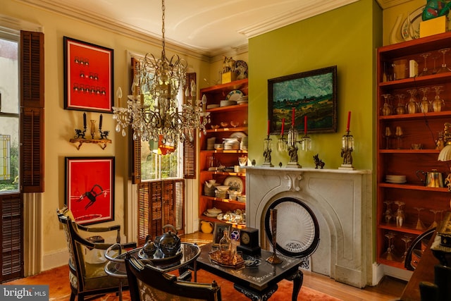 sitting room with crown molding, a chandelier, and hardwood / wood-style floors