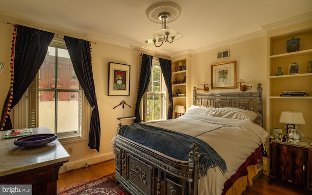 bedroom with crown molding, multiple windows, a chandelier, and dark hardwood / wood-style flooring