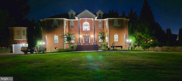 view of front of home with a yard and a garage