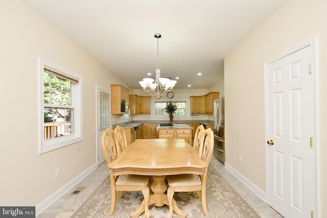 dining area featuring a notable chandelier