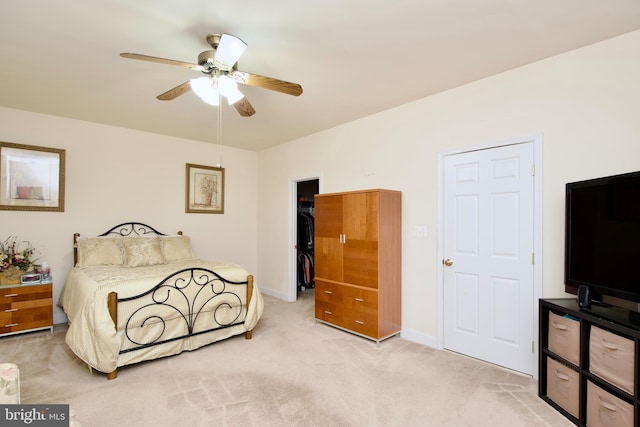 bedroom featuring a closet, light colored carpet, and ceiling fan