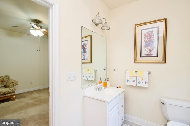 bathroom with vanity, toilet, and ceiling fan