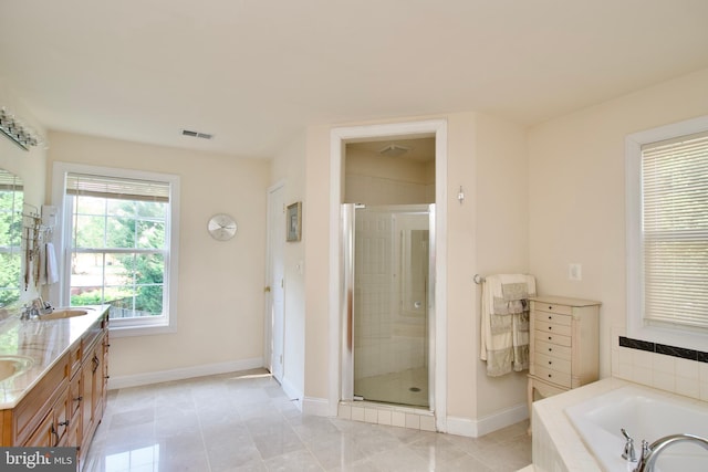 bathroom with vanity, shower with separate bathtub, and tile patterned flooring