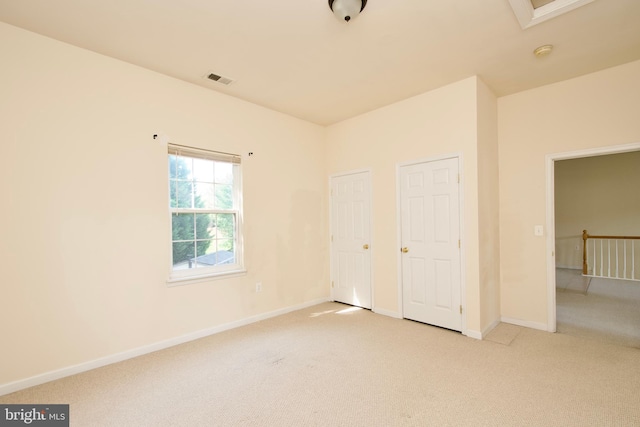 unfurnished bedroom with light carpet