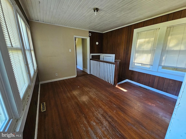 unfurnished room with crown molding, wood walls, hardwood / wood-style flooring, and wood ceiling