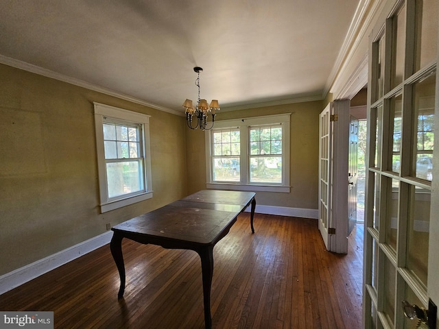 dining room with an inviting chandelier, dark wood-type flooring, plenty of natural light, and crown molding