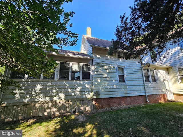 view of property exterior with a lawn