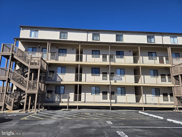 view of building exterior featuring uncovered parking