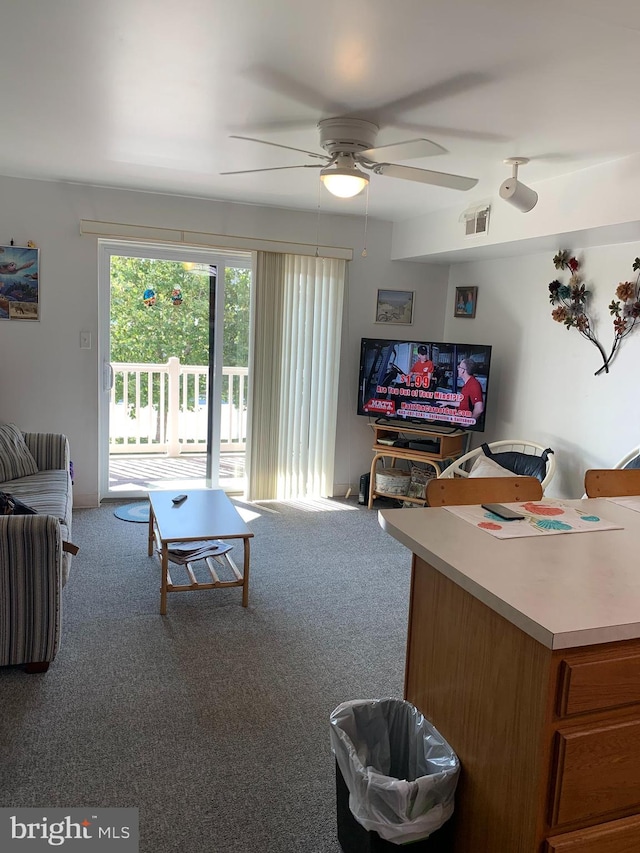 living room featuring carpet, visible vents, and ceiling fan