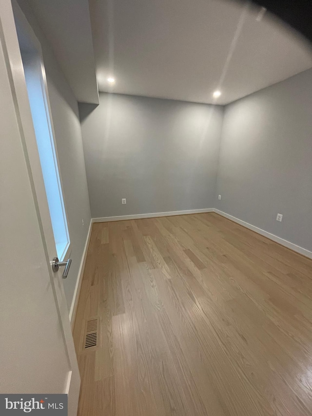 spare room with hardwood / wood-style floors