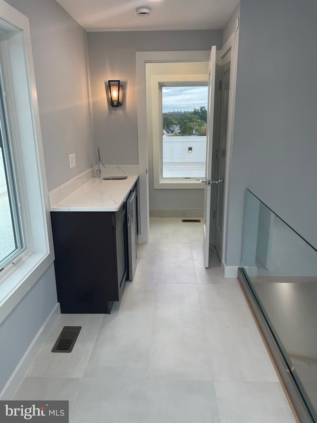 bathroom with tile patterned flooring and vanity