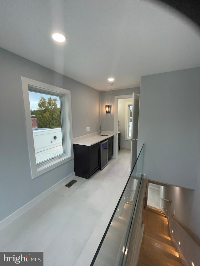 kitchen featuring hardwood / wood-style floors, decorative light fixtures, and sink