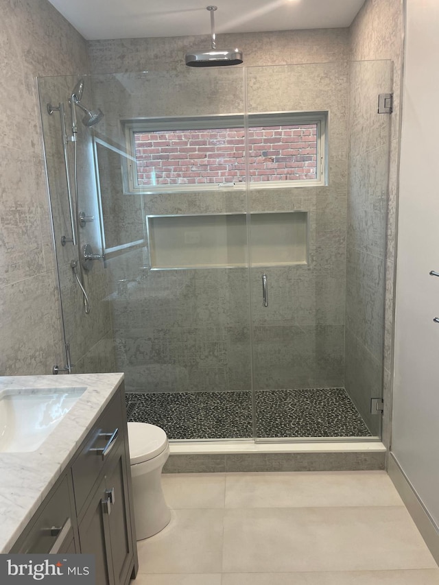 bathroom with tile patterned floors, toilet, an enclosed shower, and vanity