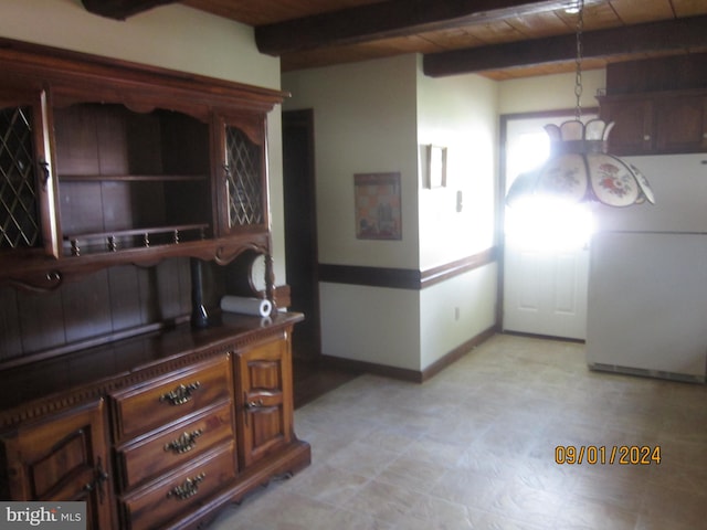 interior space with white refrigerator, beamed ceiling, and wood ceiling