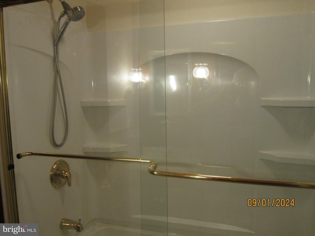 bathroom featuring a shower with shower door