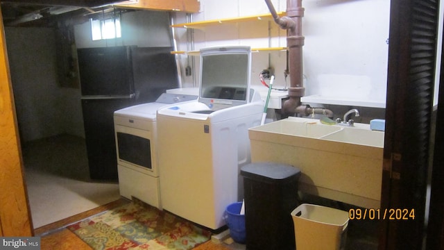 washroom with independent washer and dryer and sink