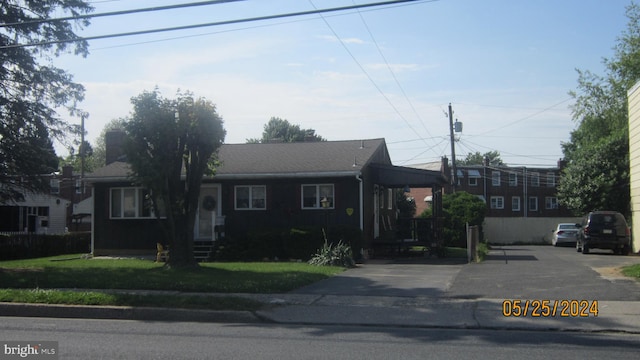 ranch-style home with a front lawn