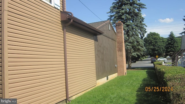 view of property exterior featuring a yard