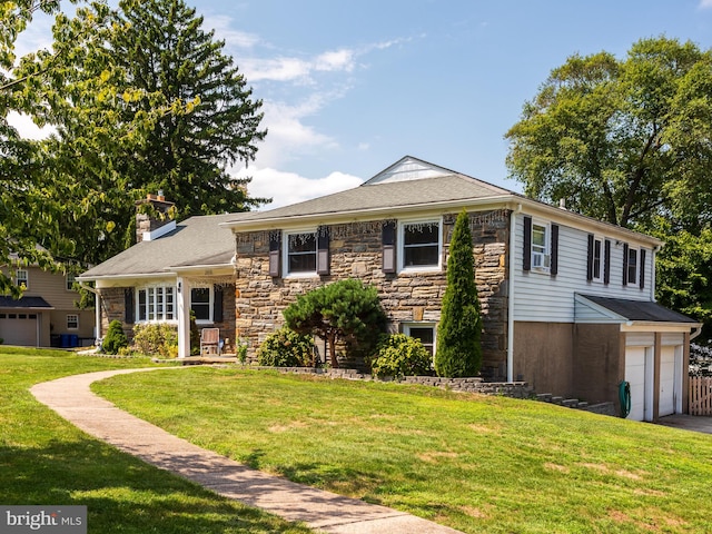 view of front of house featuring a garage and a front lawn