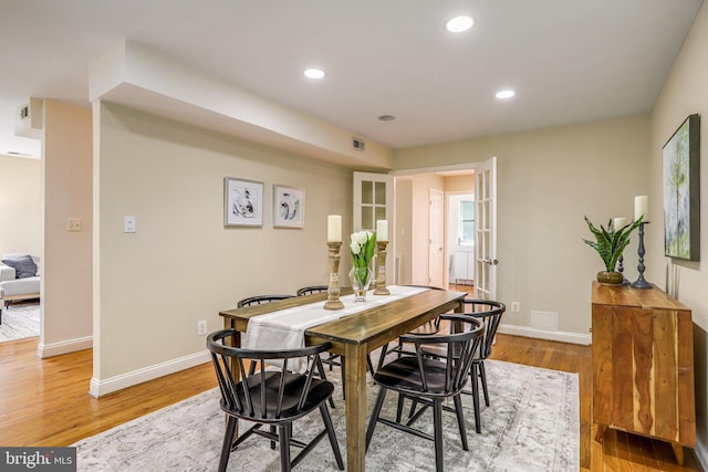 dining space with light wood-type flooring