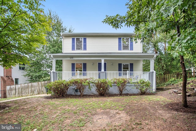 traditional-style house with covered porch and fence