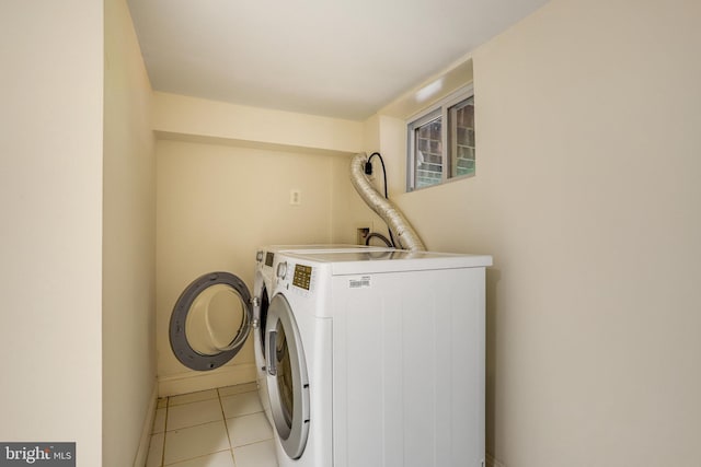 washroom with washing machine and dryer and light tile patterned floors