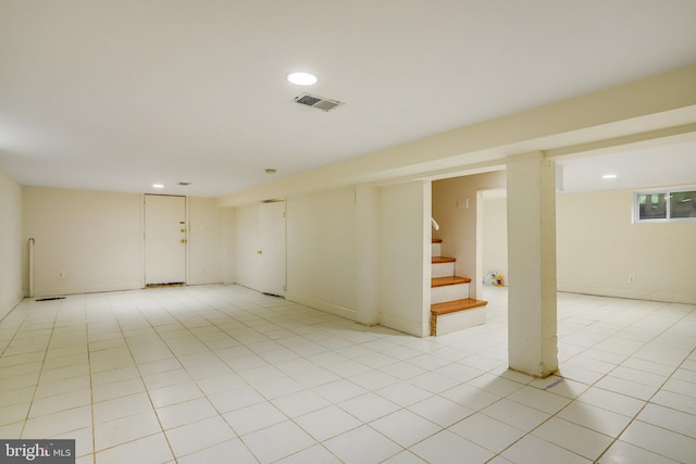 basement featuring light tile patterned floors