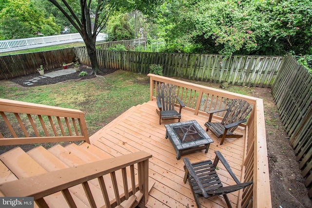 wooden terrace featuring an outdoor fire pit