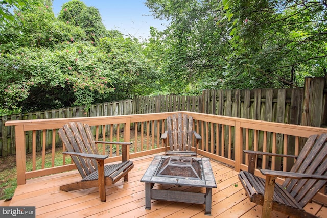 wooden deck featuring a fire pit