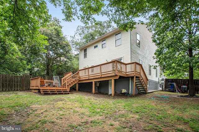 back of house featuring a yard and a wooden deck