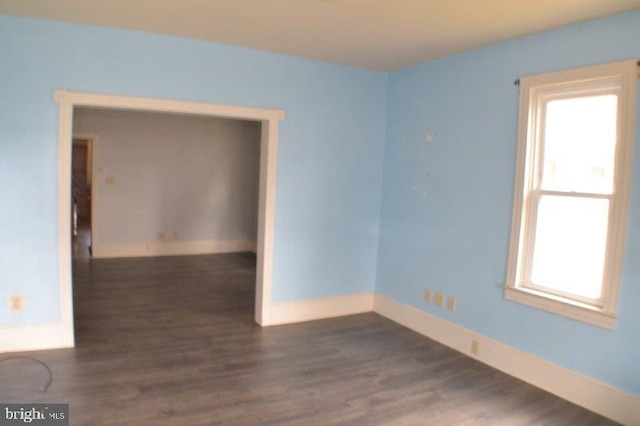 empty room with dark hardwood / wood-style floors