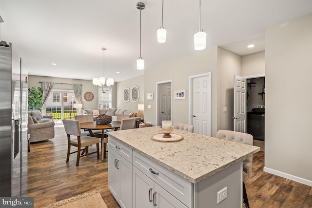 kitchen featuring hanging light fixtures, white cabinetry, dark hardwood / wood-style floors, and a kitchen island