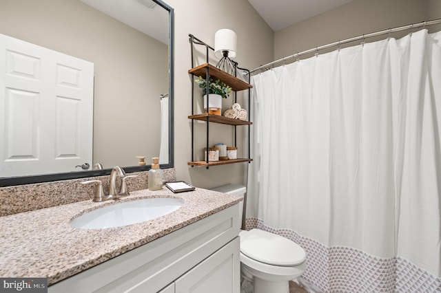 bathroom with vanity, toilet, and curtained shower